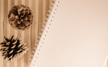 blank spiral notepad notebook with pencil on brown bamboo backgroundの写真素材