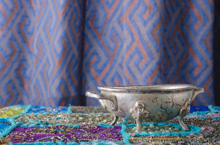 the Moroccan metal bowl placed on a table.の写真素材
