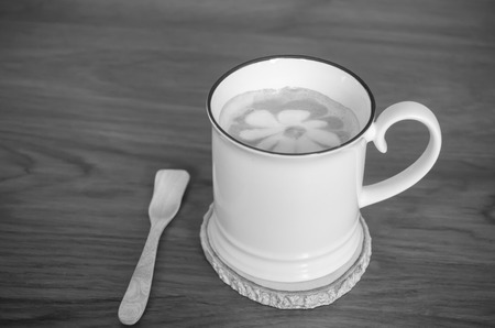 Cup of cappuccino coffee on wooden table backgroundの写真素材