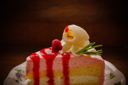 peice of creme cake with litchi on wood tableの写真素材