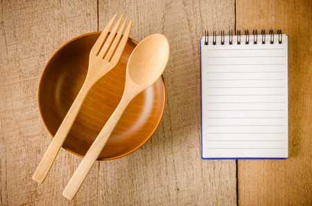 Blank note book with wooden spoon on tabletopの写真素材