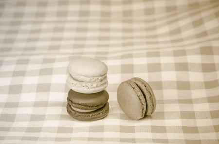 the colorful macaroons on checkered tablecloth