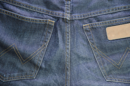 The Worn blue denim jeans textureの写真素材