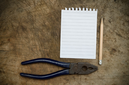 Blank notebook paper and used pencil on wood backgroundの写真素材