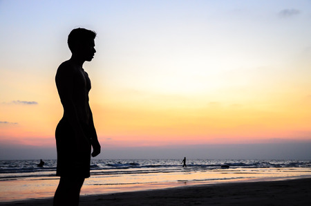 Man silhouette stand alone on the beachの写真素材