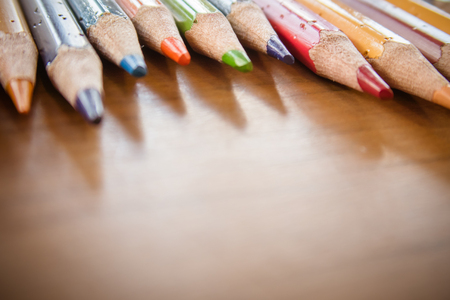 Wooden colorful pencils on a old wooden backgroundの写真素材