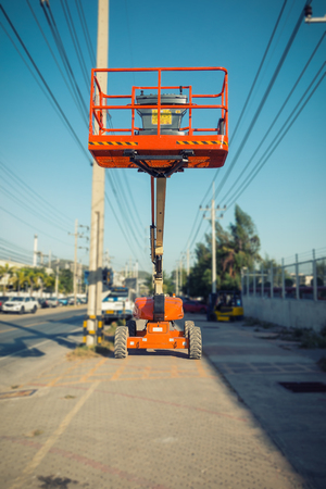 Lifting boom lift in construction site.