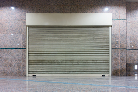 Roller shutter door and wall granite background.の写真素材