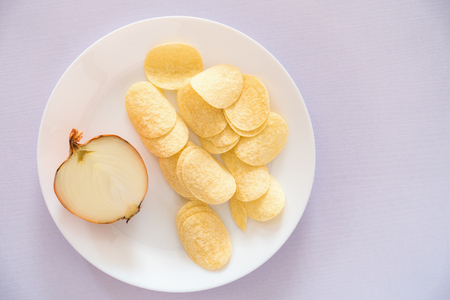 Potato onion chips on white wooden table., Top viewの写真素材