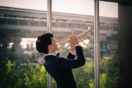 Musicain playing instrument trumpet in the hall.の写真素材
