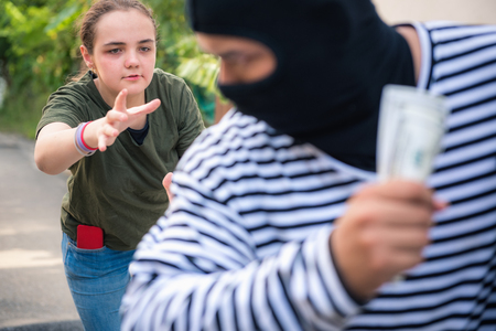 Robber snatching money and bag from women on the street., Thief money conceptsの写真素材