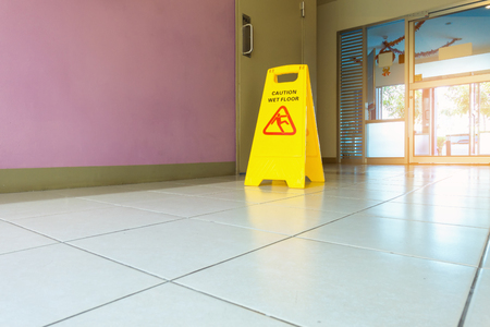 Caution wet flooring signboard and cleaningの写真素材