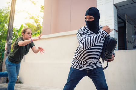 Robber snatching money and bag from women on the street., Thief, Robbery conceptsの写真素材