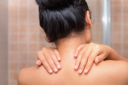 Portrait of woman massaging her neck and shoulders after too much work., Healthcare conceptの写真素材