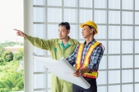 Portrait of engineers and achitects talking about shop drawing and inspection at site., Business constructionの写真素材