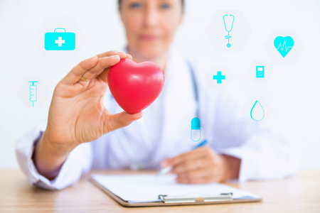 Portrait of woman doctor with holding red heart., Health care concept.の写真素材