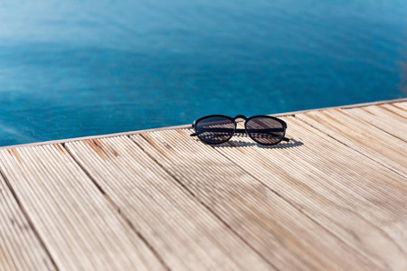 Summer concept, Sunglasses on the terrace beside swimming pool.の写真素材