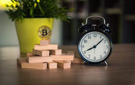 Dominoes effect of bit coin and alarm clock., Financial, Money currency and stock exchange concept.の写真素材