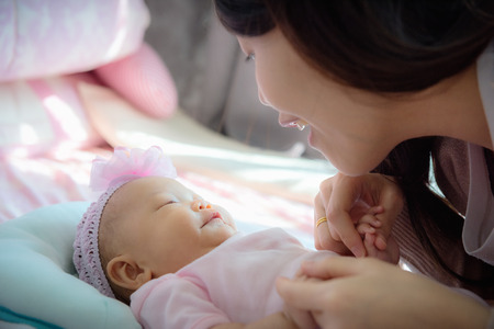 Couple mother and daughter talking something together in bedroom., Family concept