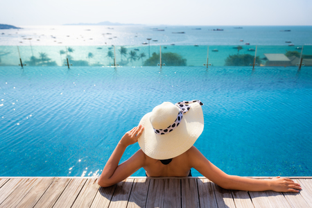 Summer holidays on the beach., Portrait of woman relaxing in swimming pool.の写真素材