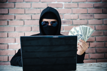 Computer hacker trying to accessing personal information privacy and showing income money.の写真素材