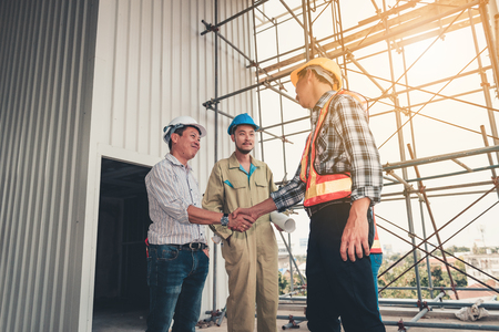 Project management team of engineer and architect are handshake together after dealing their project., Business construction concept.の写真素材