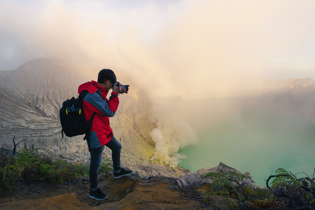 Photographer is shooting picture on top of mountain at sunrise scene., Kawah Ijen volcano.の写真素材