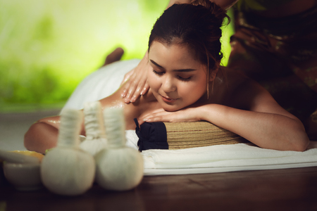 Thai girls therapist body spa massage and lying relaxation in business massaging and salon shop., Pretty attractive asian woman is relaxing by beauty skin care after traveling in Thailand.の写真素材