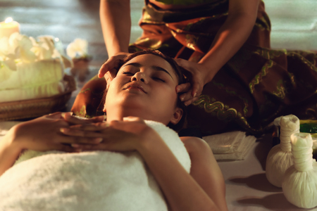 Thai girls therapist body spa massage and lying relaxation in business massaging and salon shop., Pretty attractive asian woman is relaxing by beauty skin care after traveling in Thailand.の写真素材