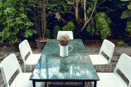 Home and outdoor gardening decoration with bouquet in a vase layout on granite table desk., House or...