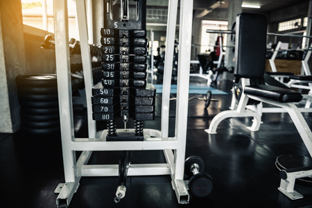Stack of weight lifting with adjuster in fitness gym., Steel metal of Workout bodybuilding equipment., Sport instrument and healthcare concept.の写真素材