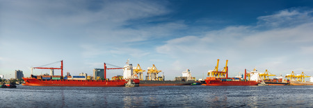 Transportation and shopping logistics loading dock terminal., Container import and export of sea freight transport industrial., Panorama of port maritime and harbor cargo shipyard with crane bridge.の写真素材