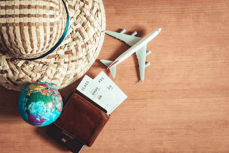 Travel destination explore planning on vacation trip., Layout of journey accessories with straw hat, pocket, passport, air ticket, airplane model on table top view. Hipster lifestyle conceptの写真素材