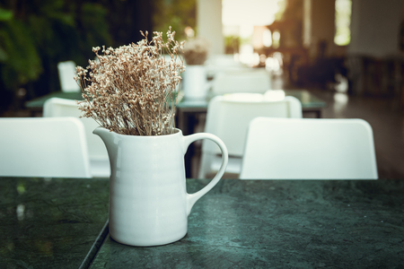 Home and outdoor gardening decoration with bouquet in a ceramic vase layout on granite table desk., House or restaurant shop of resting area design.の写真素材