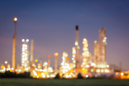 Abstract defocusing blurred of oil and gas refinery manufacturing plant., Bokeh light of Petrochemical distillation process buildings., Factory of power and energy industrial at twilight sunset.の写真素材