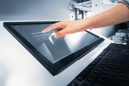 Closeup of woman hand is touching interactive screen monitor for typing input username and password in security verification system. Technology communication network and business connecting web.の写真素材