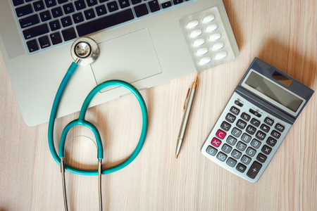 Stethoscope and Calculator on Doctor Office Table., Table Workspace Desktop for Examining Patient Health., Business Healthcare Insurance and Medicine Concept.の写真素材