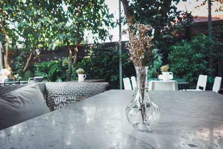 Home and Outdoor Gardening Decoration With Bouquet in a Glass Vase Layout on Granite Table Desk., House or Restaurant Shop of Resting Area Design.の写真素材