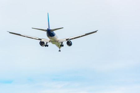 An Airplane is Flying in The Clouds Sky on Vacation Journey, International Aviation and Passengers Transportation, Holiday Trip and Traveling Tourist Concept.の写真素材