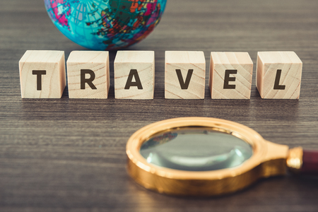 Navigation Explore of Journey Planning., Travel Destination and Expedition Plan Vacation trip., Close Up of Layout Magnifying Glass, Global Model, Wooden Cube With Word Text on a Table. Travel Conceptの写真素材