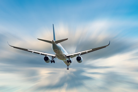 An Airplane is Flying in The Clouds Sky on Vacation Journey, International Aviation and Passengers Transportation, Holiday Trip and Traveling Tourist Concept.の写真素材