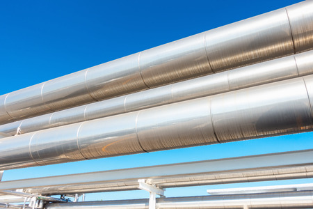 Chiller or Steam Pipeline and Insulation of Manufacturing in Oil and Gas Industrial, Petrochemical Distribution Pipe at Refinery Plant. Overhead Steel Pipe Support and Cooling System.の写真素材