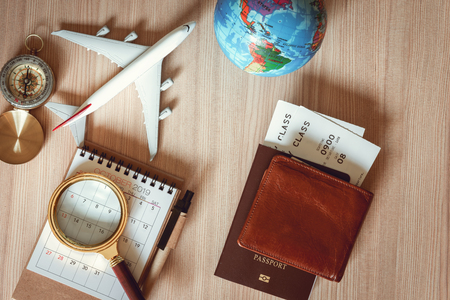 Navigation Explore of Journey Planning., Travel Destination and Expedition Plan Vacation Trip., Top View of Layout Magnifying Glass, Calendar, Compass, Airplane Model and Global Model on The Table.の写真素材
