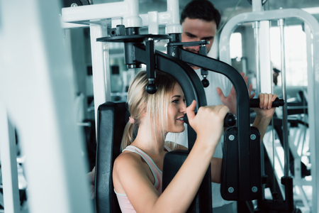 Portrait of Couple Love in Fitness Training With Bodybuilder Equipment., Young Couple Caucasian are Working Out and Training Together in Gym Club., Sport and Healthy Concept.の写真素材