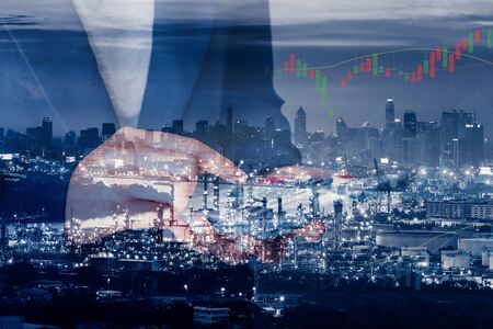 Business Accountant and Financial Trading Double Exposure Concept, Business Woman Using Calculator for Stock Investment With Oil Refinery Plant Background., Strategy Accounting and Investing Trade.の写真素材
