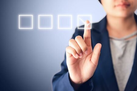 Business Woman Pressing Satisfaction Check List Icon for Customer Feedback on Touch Screen., Media Survey or Poll Questionnaire, Efficiency Performance Concept, Multimedia Iconic Surveying Data.の写真素材