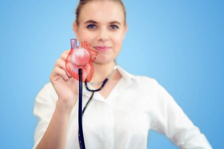 Female Medical Doctor is Holding Stethoscope for Heart Model Check Up in Laboratory, Scientist Practitioner Analyzing Health Problem With Technology 3D Heart Model., Healthcare/Medicine Occupation.の写真素材