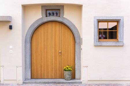 Architecture Vintage Wooden Doorway and Colorful of Flowers Decoration, Home Decorative Design and Plantation. Single Wood Door in Old Town at Switzerland. Exterior Architectural Designingの写真素材