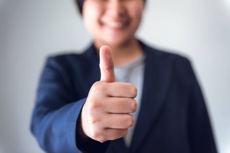 Business Woman Accountant Giving Thumbs Up While Looking at Camera, Close-Up Portrait of Businesswoman Showing Raise Hands and Thumbs Up for Good Satisfaction Attitude. Business Financial/Accounting.の写真素材