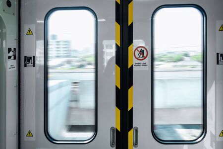 Automatic Metro Skytrain Doorway Inside Vehicle Transport Seat, Electric Security Entrance Door of Public Transportation Train in Urban City While Operating Movement. Passengers Safety System Concept.の写真素材